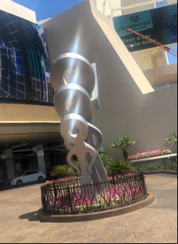 The new stainless steel sculpture outside The STRAT features three figures that face toward the very top of the building.